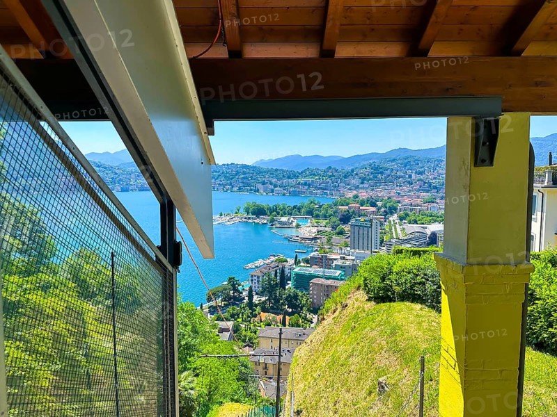 Panoramic View From Funicular Railway over Lake Lugano and Mountain View and Cityscape in a Sunny Summer Day in Lugano, Ticino, Switzerland