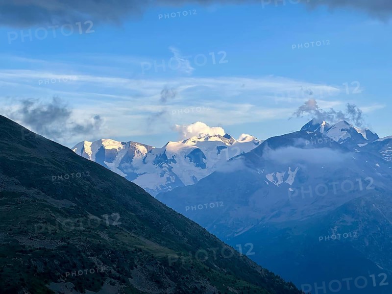 Beautiful Aerial View over the Swiss Alps with Glacier in a Sunny Summer Day and Sky with Clouds over St Moritz, Maloja, Grisons, Switzerland