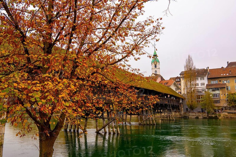 Old Town and the Historical Covered Wood Bridge Holzbrücke over River Aare in an Autumn Day in Olten, Solothurn Canton, Switzerland