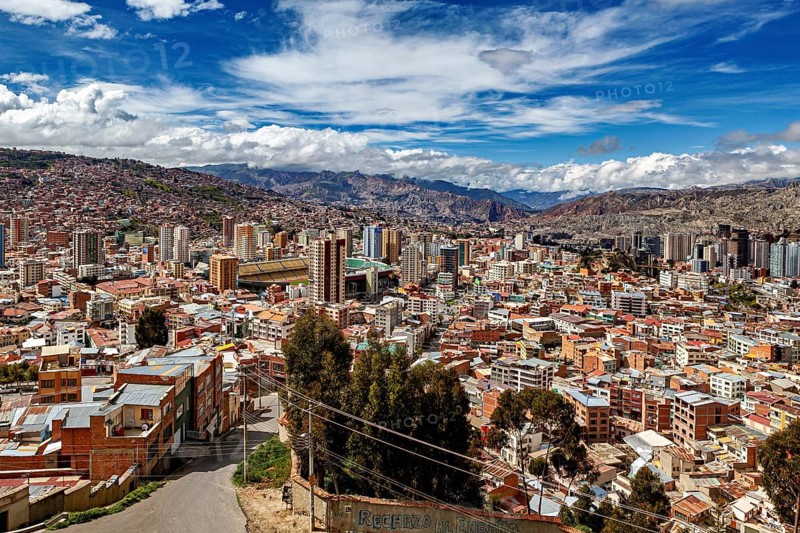 Panoramic view over La Paz with skyscrapers in front of a mountain landscape under a blue sky, The houses and skyscrapers of the city centre of La Paz in Bolivia