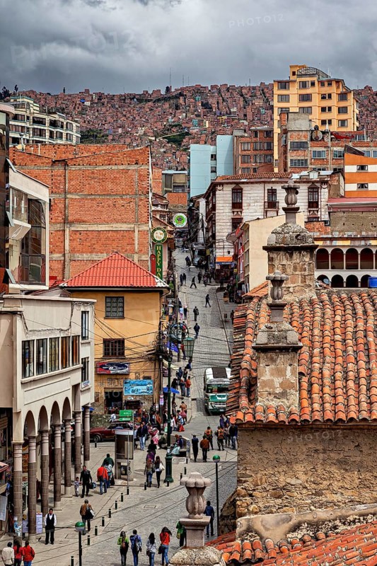 Lively city scene with tiled roofs and people on a street promenade, people in the streets of La Paz in Bolivia