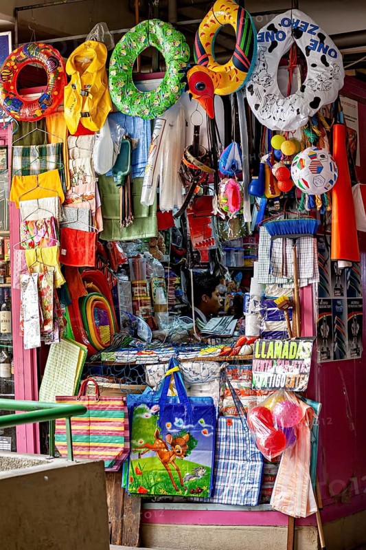 Colourful stall full of toys and colourful objects at a lively market, Small shops and restaurants in the market halls of La Paz in Bolivia