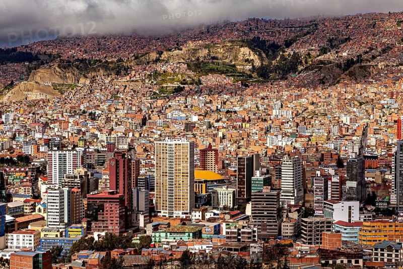 Dense cluster of houses of La Paz embedded in a hilly landscape, The houses and skyscrapers of the city centre of La Paz in Bolivia