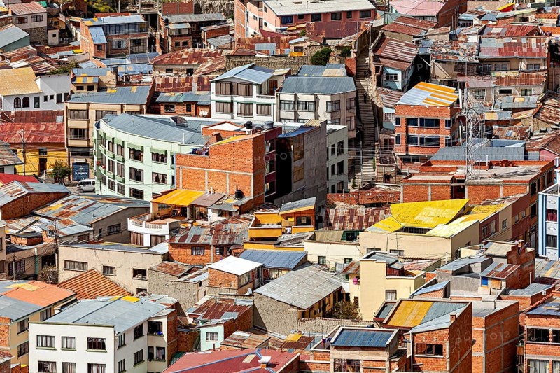 Densely packed urban cluster of houses with colourful roofs, The houses and skyscrapers of downtown La Paz in Bolivia