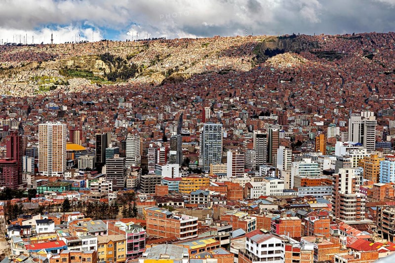 Dense development of a city with many high-rise buildings and clouds, The houses and skyscrapers of the city centre of La Paz in Bolivia