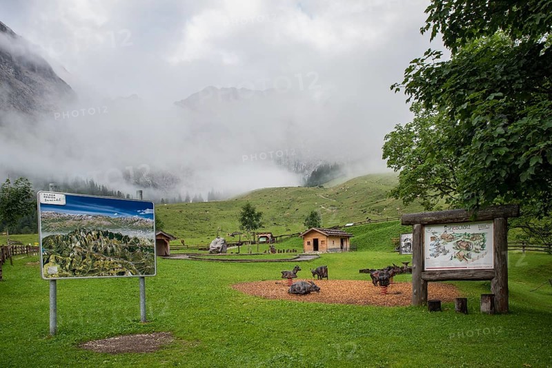 Playground and panorama board in Almdorf Eng with fog, Tyrol, Austria