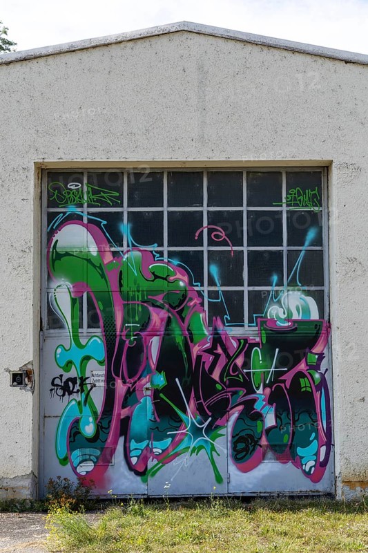 Garage door decorated with colourful graffiti and abstract shapes, at the port of Linz Upper Austria Austria