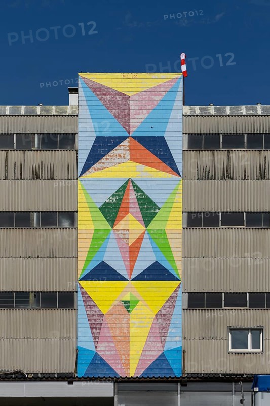 Geometric mural in bright colours on industrial façade, at the port of Linz Upper Austria Austria