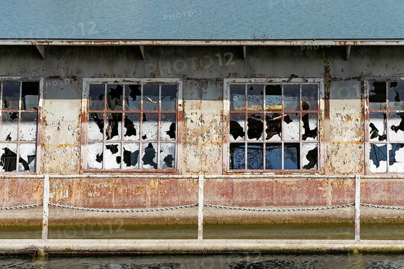 Close-up of broken windows of a rusty building on the waterfront, at the harbour of Linz Upper Austria Austria