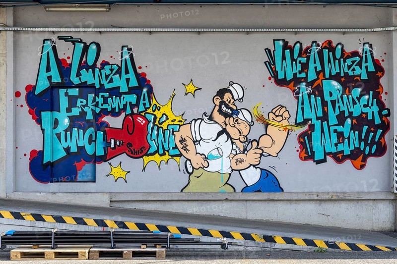 Colourful comic-style graffiti with fighting characters and lettering, at the port of Linz Upper Austria Austria