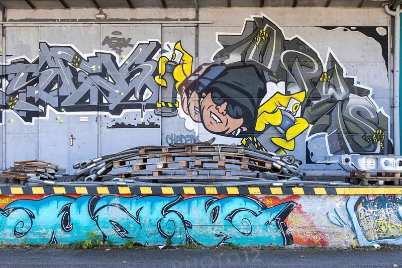 Humorous graffiti with a man and colourful lettering, at the port of Linz Upper Austria Austria