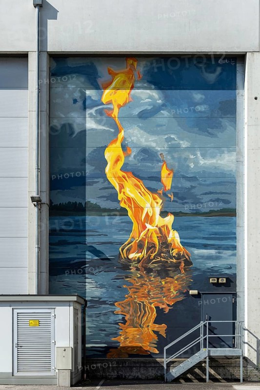 Fire flame on water surface as realistic wall painting, at the harbour Linz Upper Austria Austria