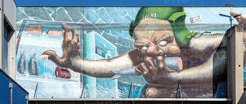 Caricature of a monster searching a fridge, as graffiti, at the harbour of Linz Upper Austria Austria