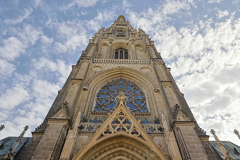 Detailed Gothic church façade rises dramatically into the cloudy sky, Maria Empfängnis Dom Linz Upper Austria Austria