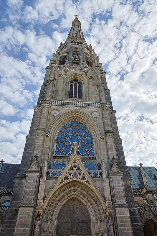 Gothic church façade with detailed stained glass windows and cloudy sky, Maria Empfängnis Dom Linz Upper Austria Austria
