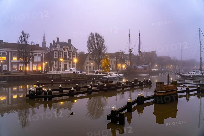 Typical canal in the foggy evening twilight, Harlingen, Friesland, Netherlands