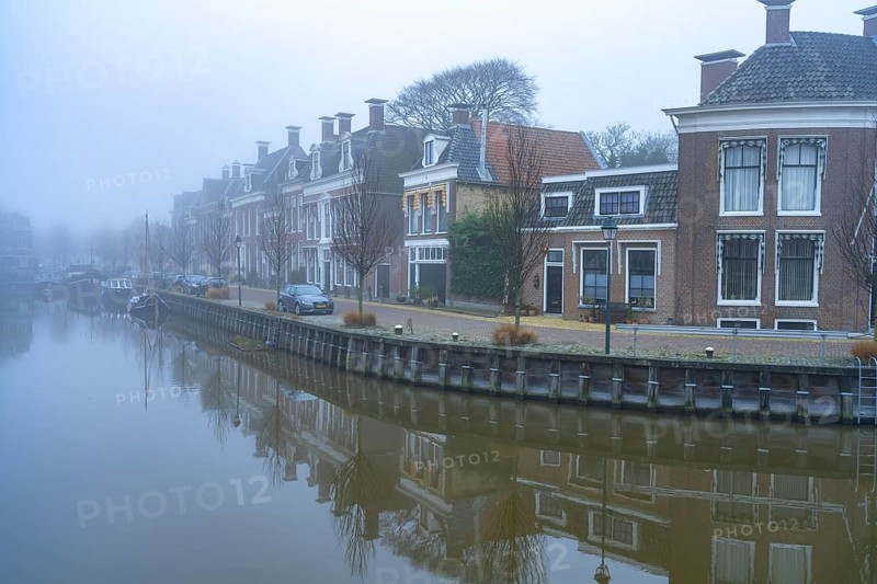 Typical canal in the winter fog, Harlingen, Friesland, Netherlands
