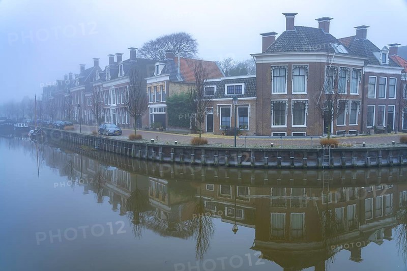 Typical canal in the winter fog, Harlingen, Friesland, Netherlands