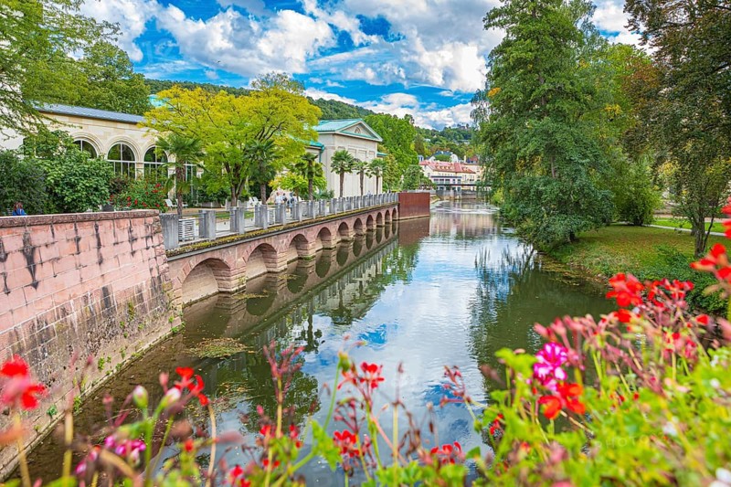 Promenade and arcade footbridge on the Franconian Saale in Bad Kissingen, Bavaria, Germany