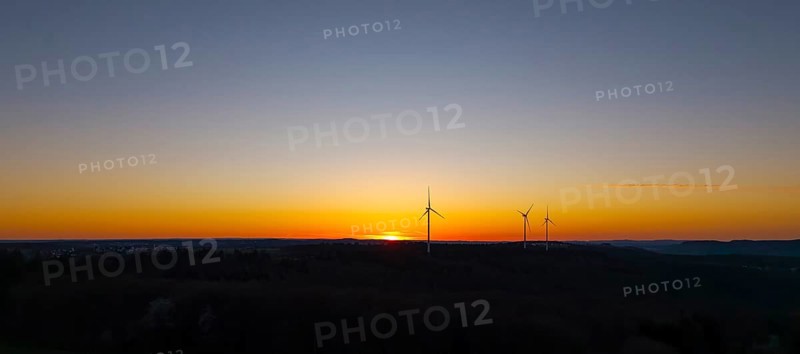 Silhouette of wind turbines at sunset in the distance, near Schorndorf im Remstal, Baden-Württemberg, Germany