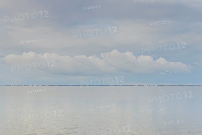 North Sea coast, special light mood over the Wadden Sea with rising water and calm wind, on the horizon the island of Juist, Norddeich, Lower Saxony, Germany