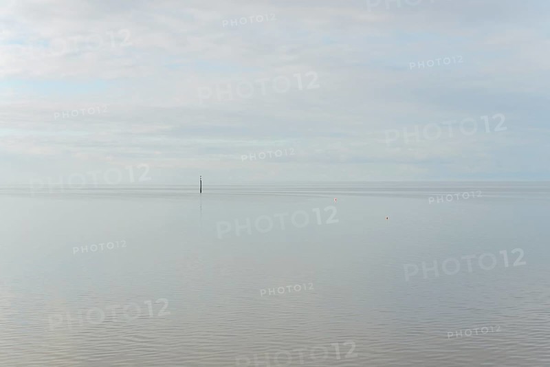North Sea coast, special light atmosphere over the Wadden Sea with rising water and calm wind, navigation sign danger spot, Norddeich, Lower Saxony, Germany