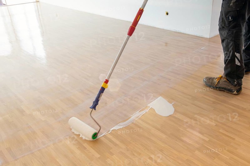 Professional sealing of a new parquet floor with lacquer