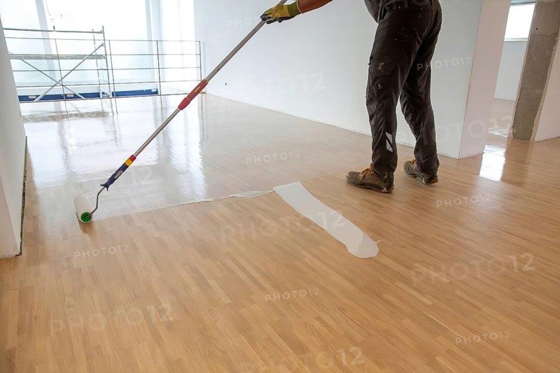 Professional sealing of a new parquet floor with lacquer