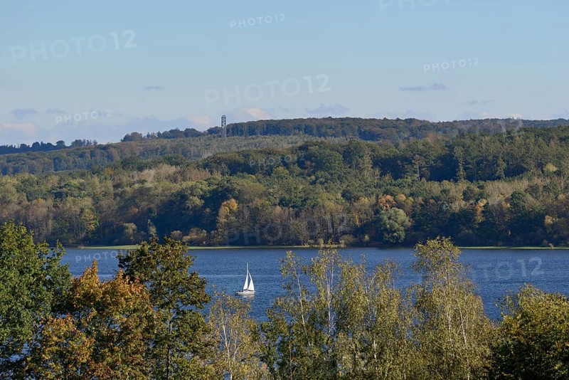 View of the Möhnesee with sailing boat and the Möhnesee tower, autumn atmosphere, blue sky, Möhnetalsperre, North Rhine-Westphalia, Germany
