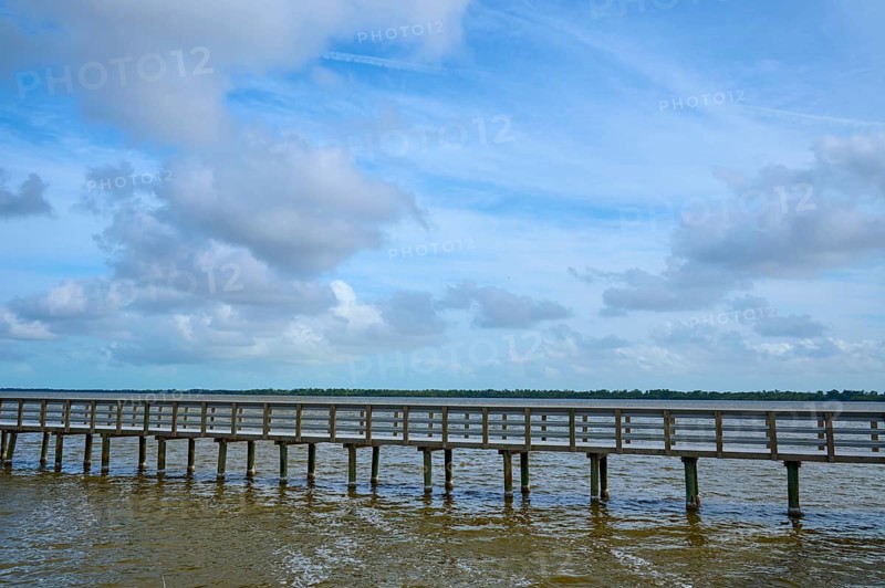 A long wooden footbridge leads over the water, the sky is cloudy, West Lake View Point, Everglades National Park, Florida, USA