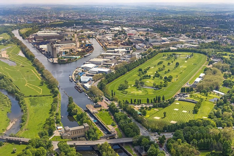 Aerial view, Raffelberg racecourse with golf course inside, Raffelberg lock, Raffelberg hydroelectric power station, Raffelberg bridge, Rhine-Ruhr harbour Mülheim, Speldorf - Northwest, Mülheim an der Ruhr, Ruhr area, North Rhine-Westphalia, Germany, Akazienallee, bridge, DE, Europe, golf, golf course, golf club, Raffelberg golf club, golf course, golf meadow, harbour, power station, aerial view, aerial photography, aerial photography, equestrian sports, racecourse, Ruhrorter Straße, sport, overview, bird's-eye view, overview