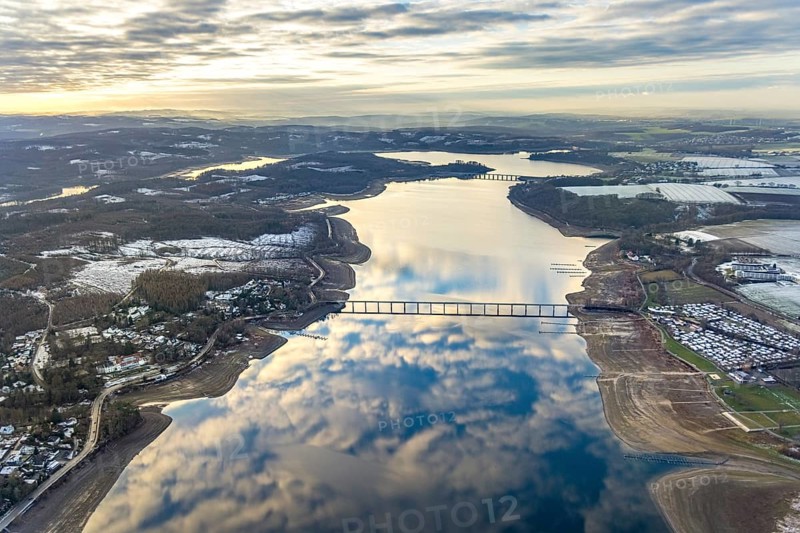 Aerial view of Lake Möhnesee in winter with snow and reflections of clouds on the water surface at low tide in Körbecke in Möhnesee in Sauerland in North Rhine-Westphalia, Germany, Sauerland, Europe, aerial view, birds-eyes view, aerial photography, aerial photography, overview, bird's eye view