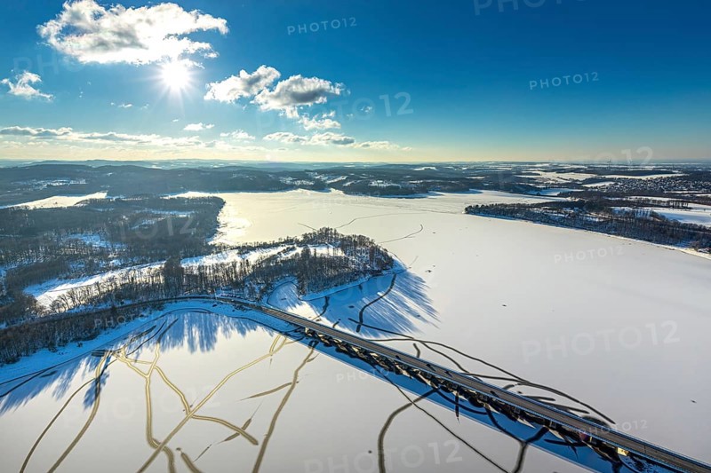 Aerial view, Möhnesee and Delecker Brücke, Delecke, Möhnesee, Sauerland, North Rhine-Westphalia, Germany, Arnsberger Straße, bridge, DE, Europe, distant view, backlight, aerial view, aerial photography, aerial photography, cracks in the ice, snow, sun, overview, bird's eye view, winter at Möhnesee, winter landscape, birds-eyes view, blue sky, overview