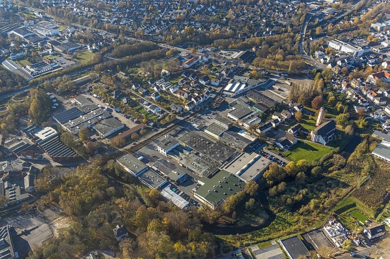 Aerial view, industrial estate Am Törnigskamp and cath. Heilig Kreuz Kirche in Menden, Sauerland, North Rhine-Westphalia, Germany, place of worship, DE, Europe, commercial enterprises, commercial area, commercial park, commercial site, commercial use, religious community, place of worship, holy site, industrial area, industrial building, industrial site, church, church community, denomination, aerial view, aerial photography, aerial photography, Menden, religion, religious site, overview, bird's-eye view, birds-eyes view, overview