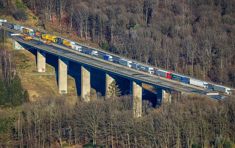 Aerial view, truck traffic jam on the Sterbecke viaduct in front of the closed Rahmede viaduct of the A45 Sauerlandlinie motorway in the Heedfeld district of Schalksmühle, Sauerland, North Rhine-Westphalia, Germany, A45, DE, Europe, truck traffic jam, aerial view, aerial photography, aerial photography, through road, Sauerlandlinie, Schalksmühle, damage to the steel structure, closure of the Rahmede viaduct, traffic jam, traffic jam, overview, traffic volume, traffic chaos, traffic infrastructure, traffic jam, bird's eye view, bird's eye view, lack of load-bearing capacity, closed Rahmede viaduct, dilapidated bridge, dilapidated bridges, overview