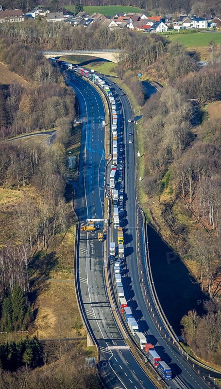 Aerial view, truck traffic jam on the Sterbecke viaduct in front of the closed Rahmede viaduct of the A45 Sauerlandlinie motorway in the Heedfeld district of Schalksmühle, Sauerland, North Rhine-Westphalia, Germany, A45, DE, Europe, truck traffic jam, aerial view, aerial photography, aerial photography, through road, Sauerlandlinie, Schalksmühle, damage to the steel structure, closure of the Rahmede viaduct, traffic jam, traffic jam, overview, traffic volume, traffic chaos, traffic infrastructure, traffic jam, bird's eye view, bird's eye view, lack of load-bearing capacity, closed Rahmede viaduct, dilapidated bridge, dilapidated bridges, overview