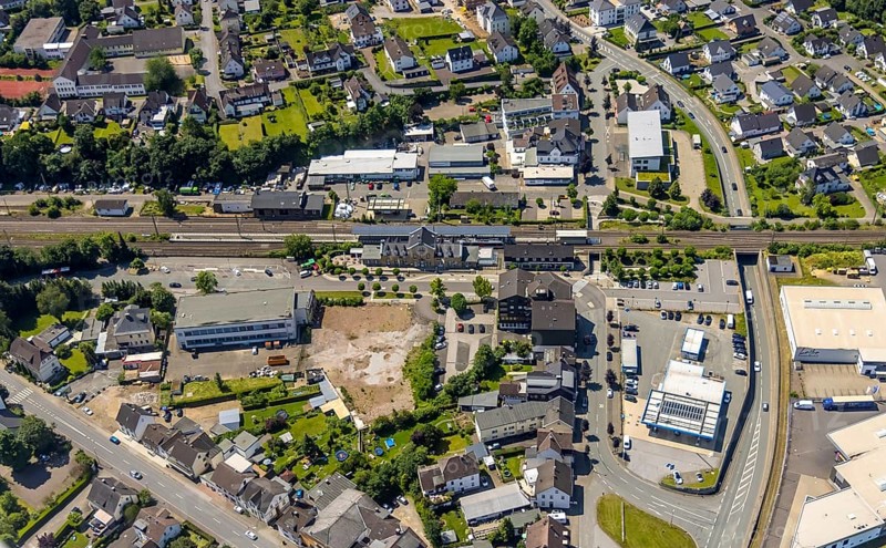Aerial view, Lennestadt-Grevenbrück railway station, EssBahnhof and KulturBahnhof, brownfield site at the forecourt, Lennestadt, Sauerland, North Rhine-Westphalia, Germany, railway station, station forecourt, building site, building plots, DEU, Deutsche Bahn AG, Europe, gastronomy, main station, main station, culture, art, aerial view, aerial photography, aerial photography, restaurant, overview, event location, bird's-eye view, birds-eyes view, cultural use, overview