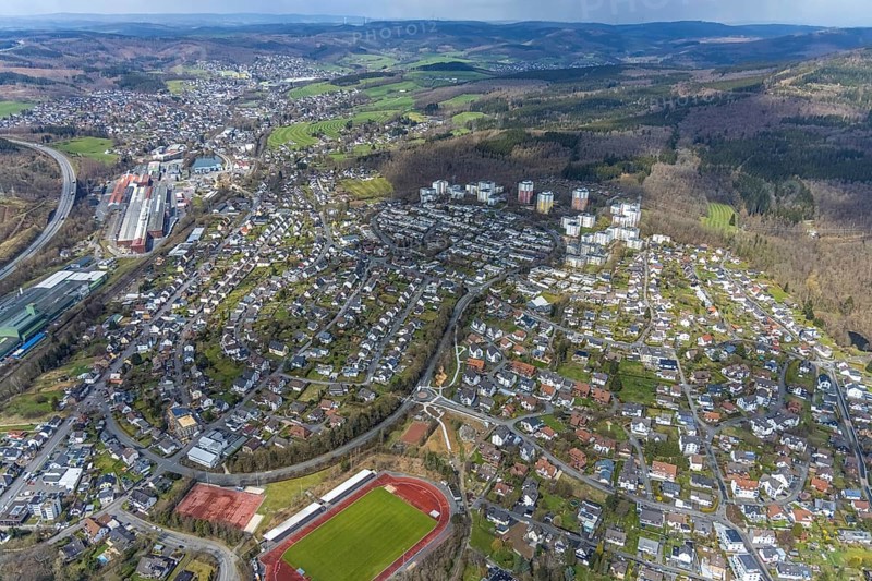 Aerial view, view of Kreuztal and Stählerwiese stadium, roundabout and construction site Hessengarten corner Zum Erbstollen, new footpath and cycle path, Kreuztal, Sauerland, North Rhine-Westphalia, Germany, construction work, construction area, building site, building plots, construction project, construction site, DE, Europe, football pitch, football stadium, Siegen-Wittgenstein district, roundabout, roundabout, athletics stadium, aerial view, aerial photography, aerial photography, sports, sports facilities, sports field, sports facility, overview, bird's-eye view, overview