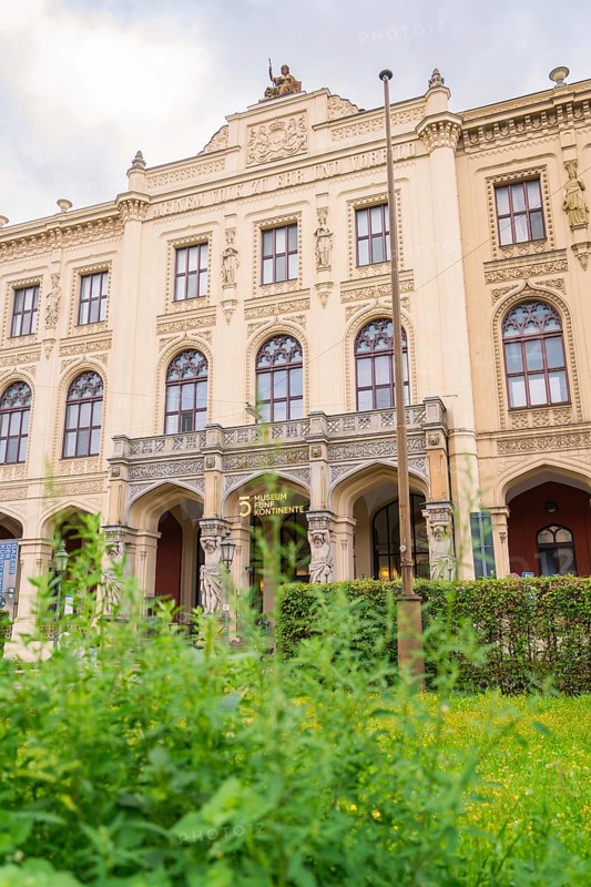 A magnificent historic building with ornate facades surrounded by lush green plants, Munich, Germany