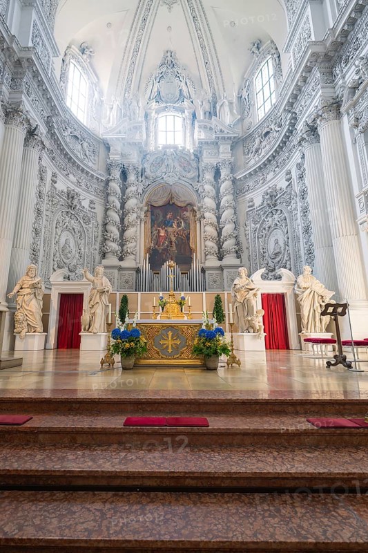 Magnificently decorated church altar in baroque architecture with sculptures and lavish ornamentation, Munich, Germany