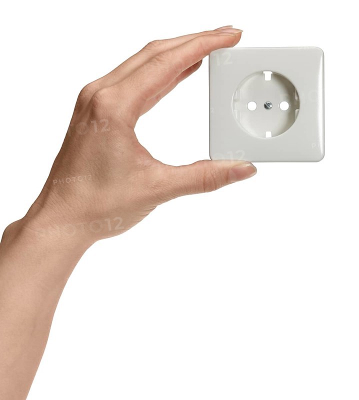 Feminine hand holding a white socket in front of white back
