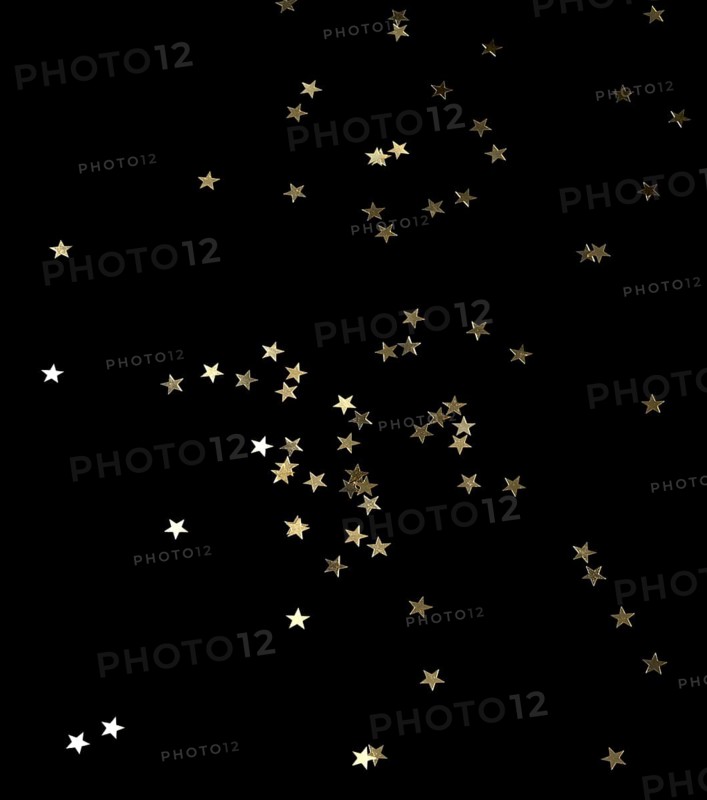 Punched small metallic stars falling in front of black back