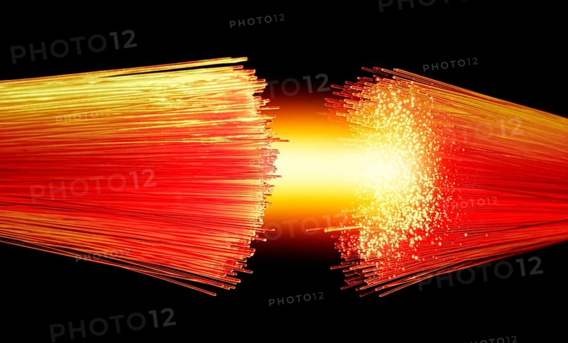 Vibrant illuminated symbolic optical fibers connection closeup in black back