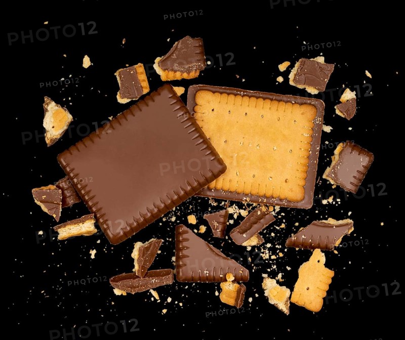 Butter biscuit cakes with chocolate and lots of broken pieces around in black back