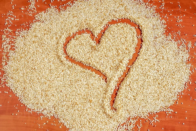 Heart-shaped trace in sesame seeds on red brown back