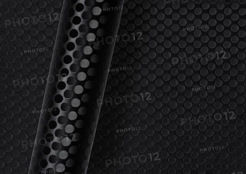 Rolled dark round dotted surface over same full frame textured background