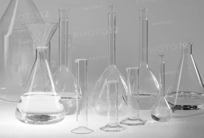 Variety of partly filled laboratory glassware