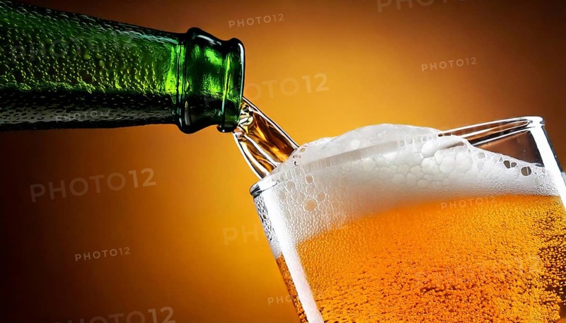 AI generated closeup image showing a bottle while pouring beer in a glass