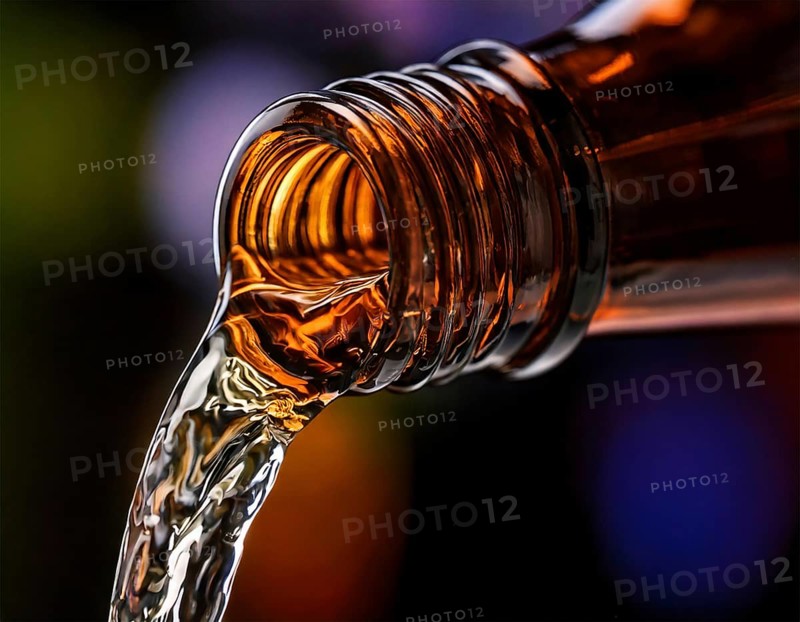 AI-generated close-up image showing a bottle as a clear drink is poured from it, AI generated