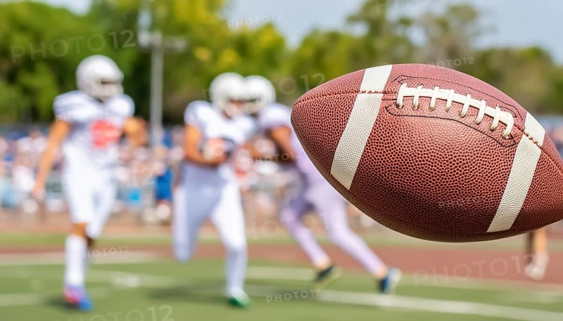 AI generated image showing a rugby scenery with ball closeup on a playing field with players
